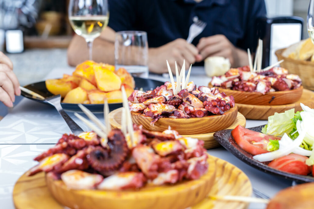People,Eating,Pulpo,A,La,Gallega,With,Potatoes.,Galician,Octopus
